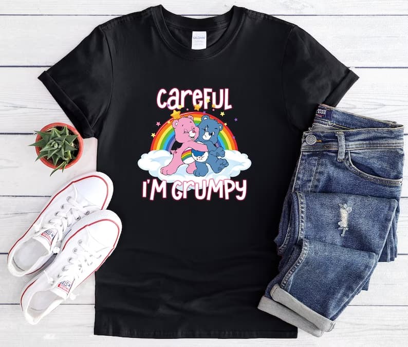 The "Bears Careful I'm Grumpy Shirt" is a humorous and playful t-shirt that's perfect for those who have a bit of a grumpy side. Made from comfortable and breathable material, this shirt features the phrase "Bears Careful I'm Grumpy" written in bold, eye-catching letters on the front. The design is playful and cheeky, suggesting that anyone who crosses your path should proceed with caution. This shirt is ideal for those who enjoy a bit of humor and want to make a statement with their clothing. It's available in various sizes, making it a great fit for people of all shapes and sizes. Whether you're out running errands or lounging around the house, the "Bears Careful I'm Grumpy Shirt" is sure to add a touch of humor and personality to your outfit. Bears Careful I’m Grumpy Shirt