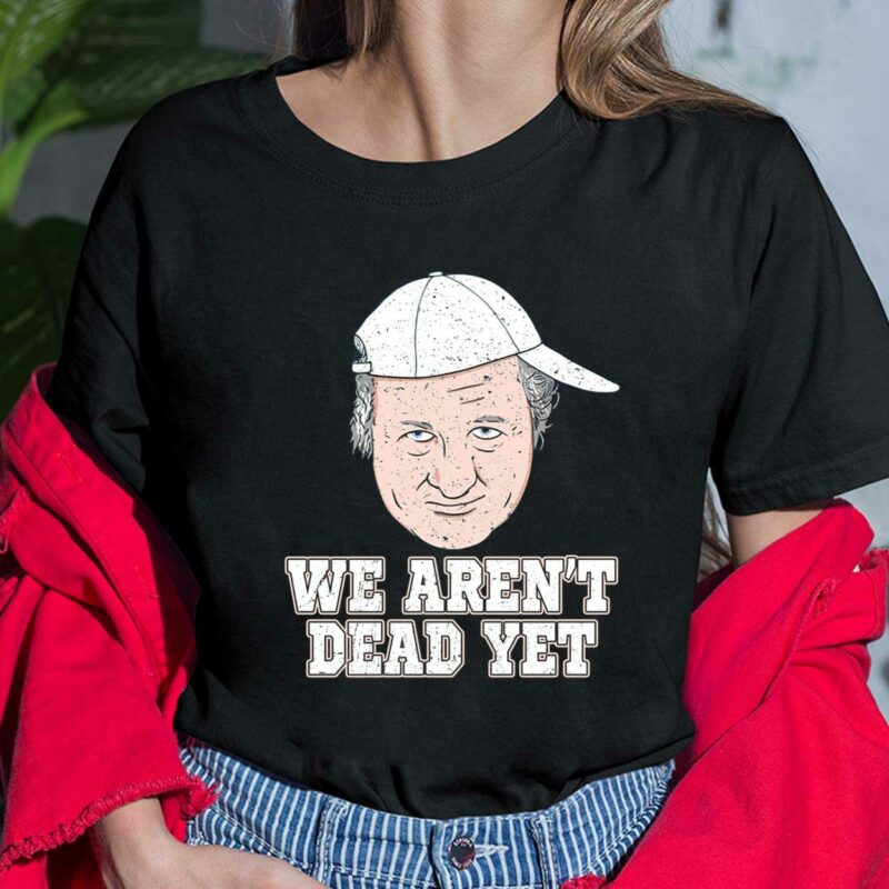 The "Bob Huggins We Aren't Dead Yet" shirt is a powerful statement piece that captures the fighting spirit of one of the most iconic coaches in college basketball history. The shirt features the name "Bob Huggins" in bold letters, along with the phrase "We Aren't Dead Yet" printed above it, creating a message of resilience and determination. Bob Huggins We Aren’t Dead Yet Ladies Shirt